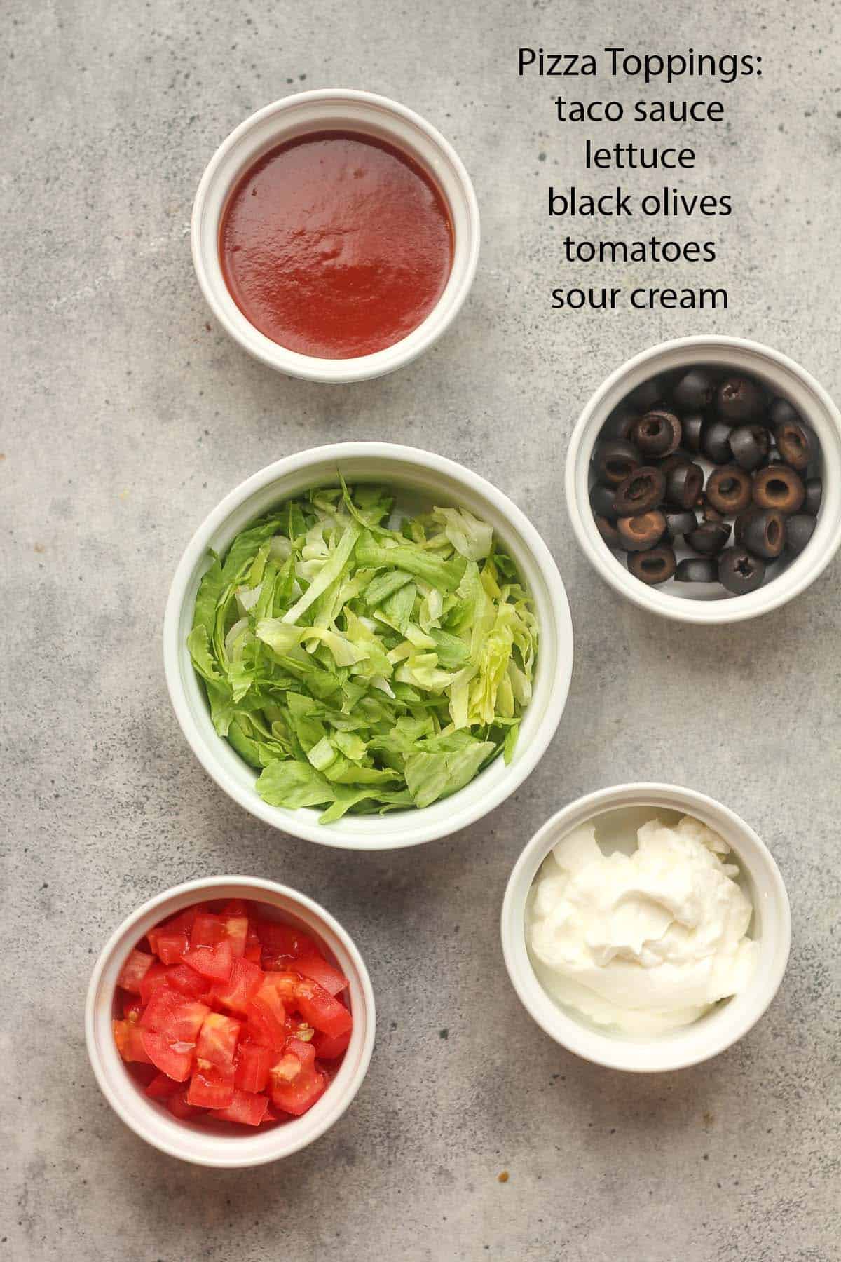The pizza toppings in small bowls.