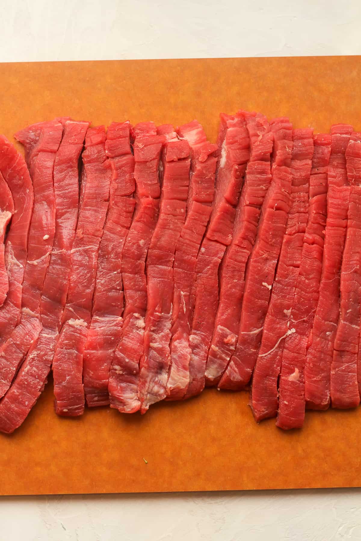 A board of sliced flank steak.