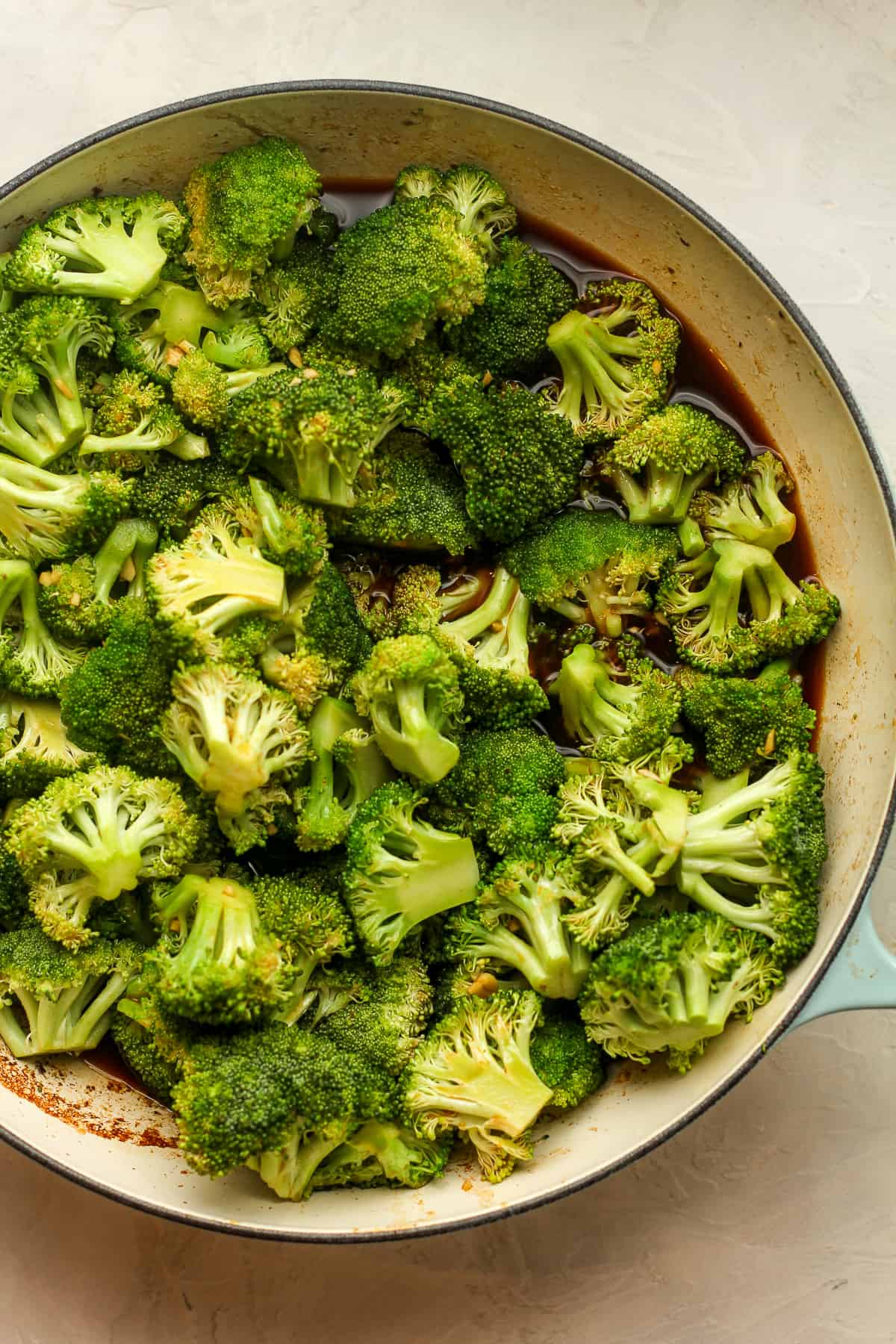 The broccoli and sauce in a pan.