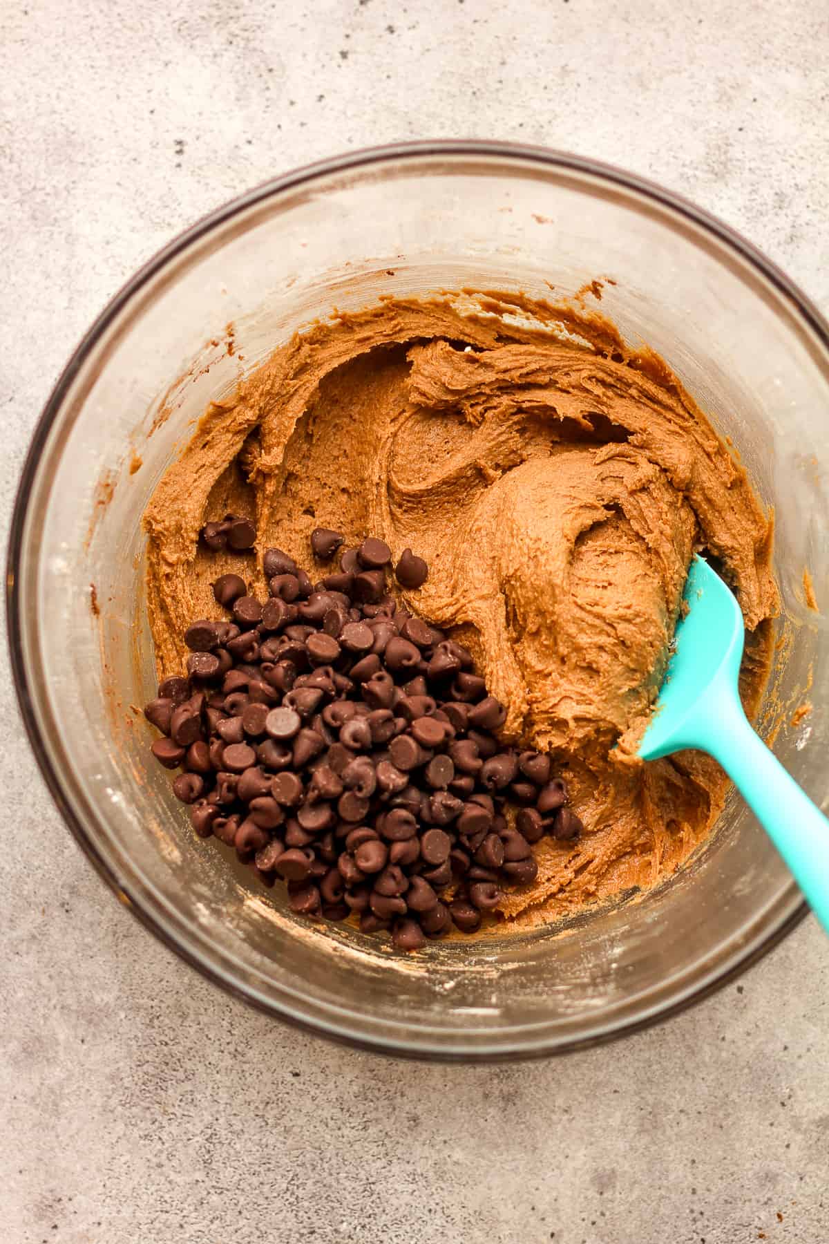 A bowl of the chocolate cookie dough plus chocolate chips on top.