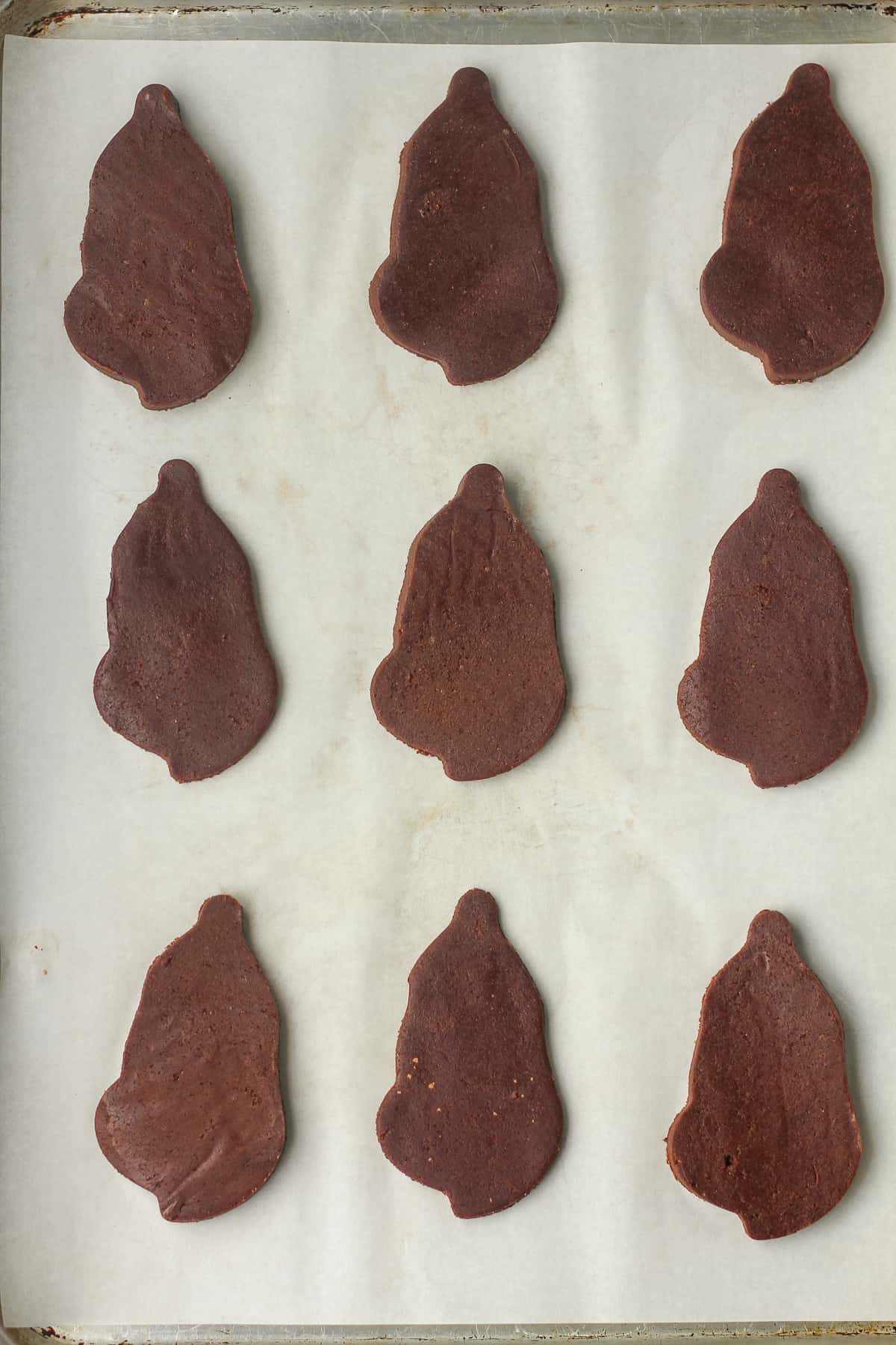 The chocolate cut outs on a baking sheet.