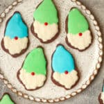 A large plate of decorated cut-out gnome cookies.