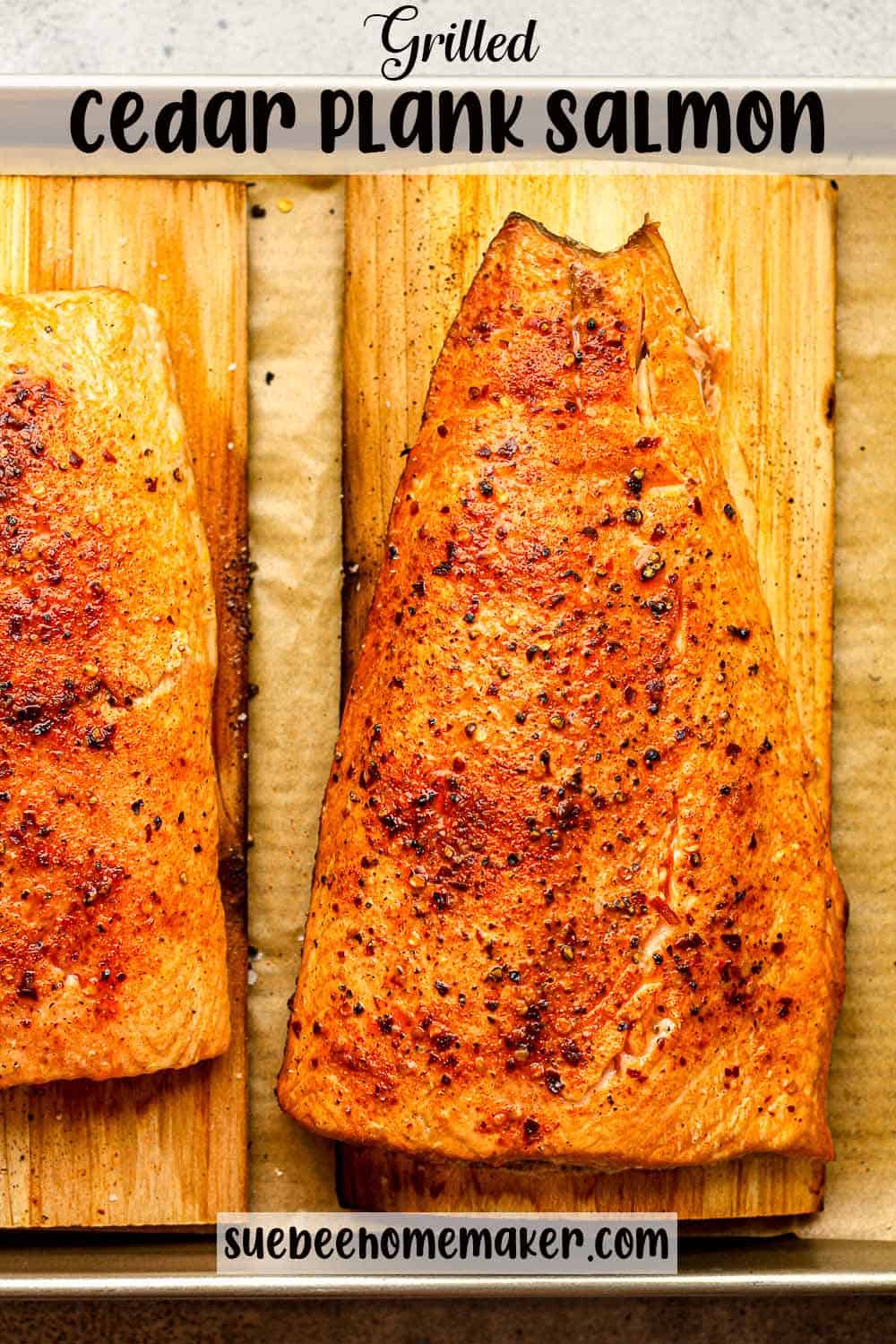 Two large pieces of grilled salmon on cedar planks