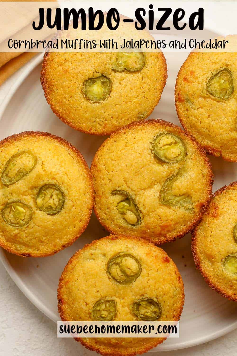 A plate of jumbo-sized cornbread muffins with jalapeños and cheddar cheese.