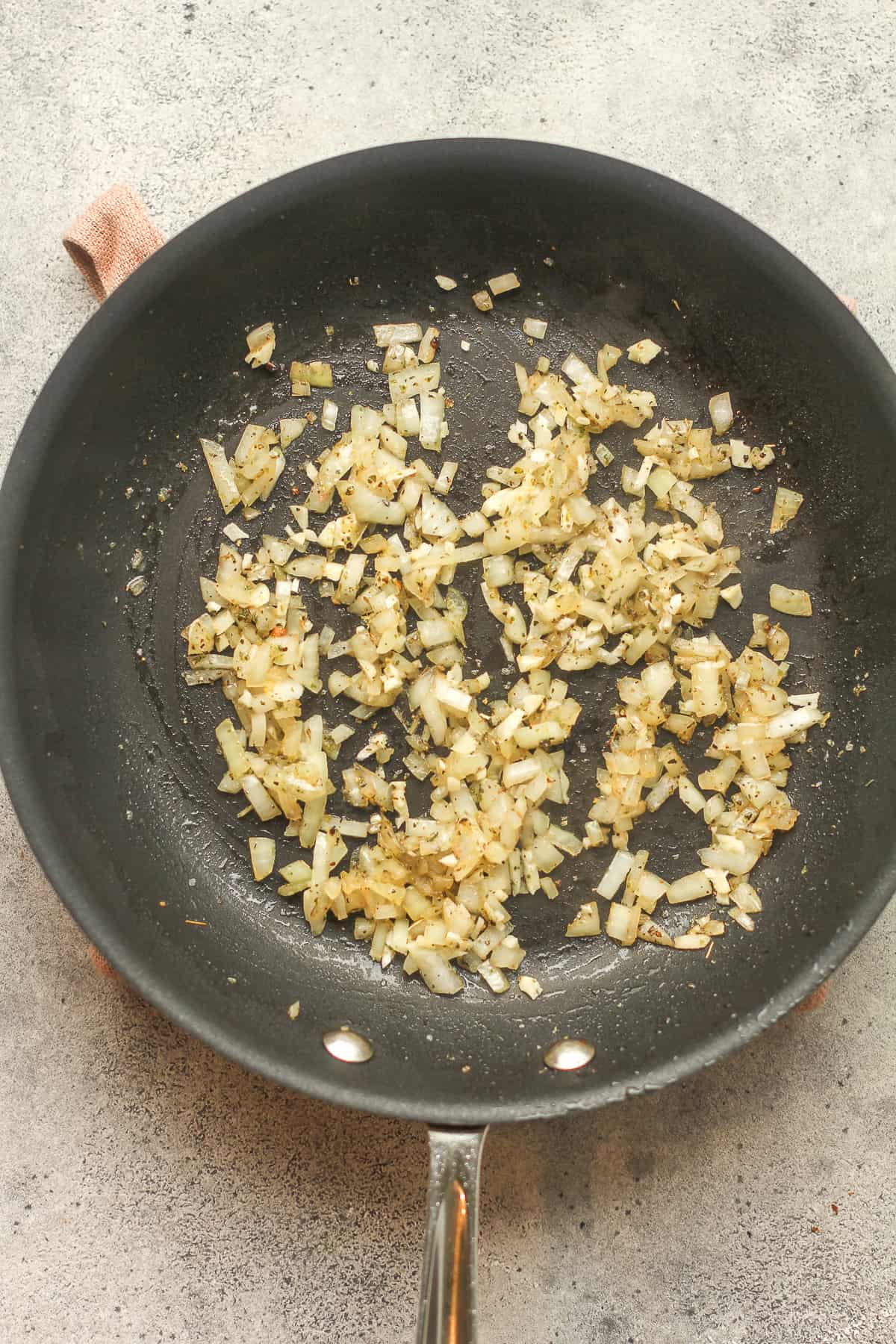 A pan of sautéed onions and seasonings.