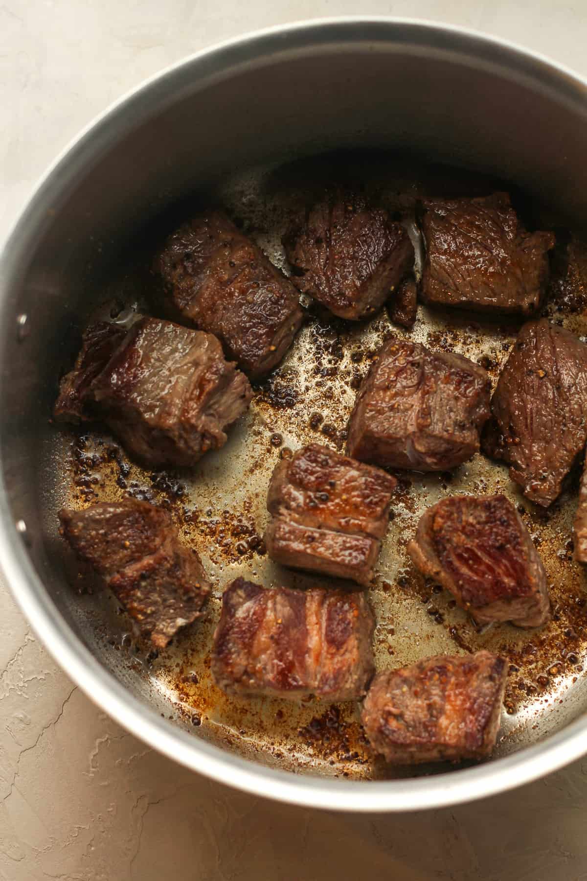 A pot of the browned chunks of beef.