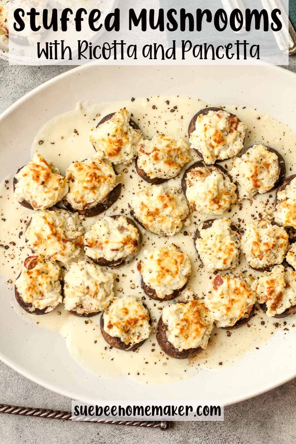 A serving dish of stuffed mushrooms with ricotta and pancetta.