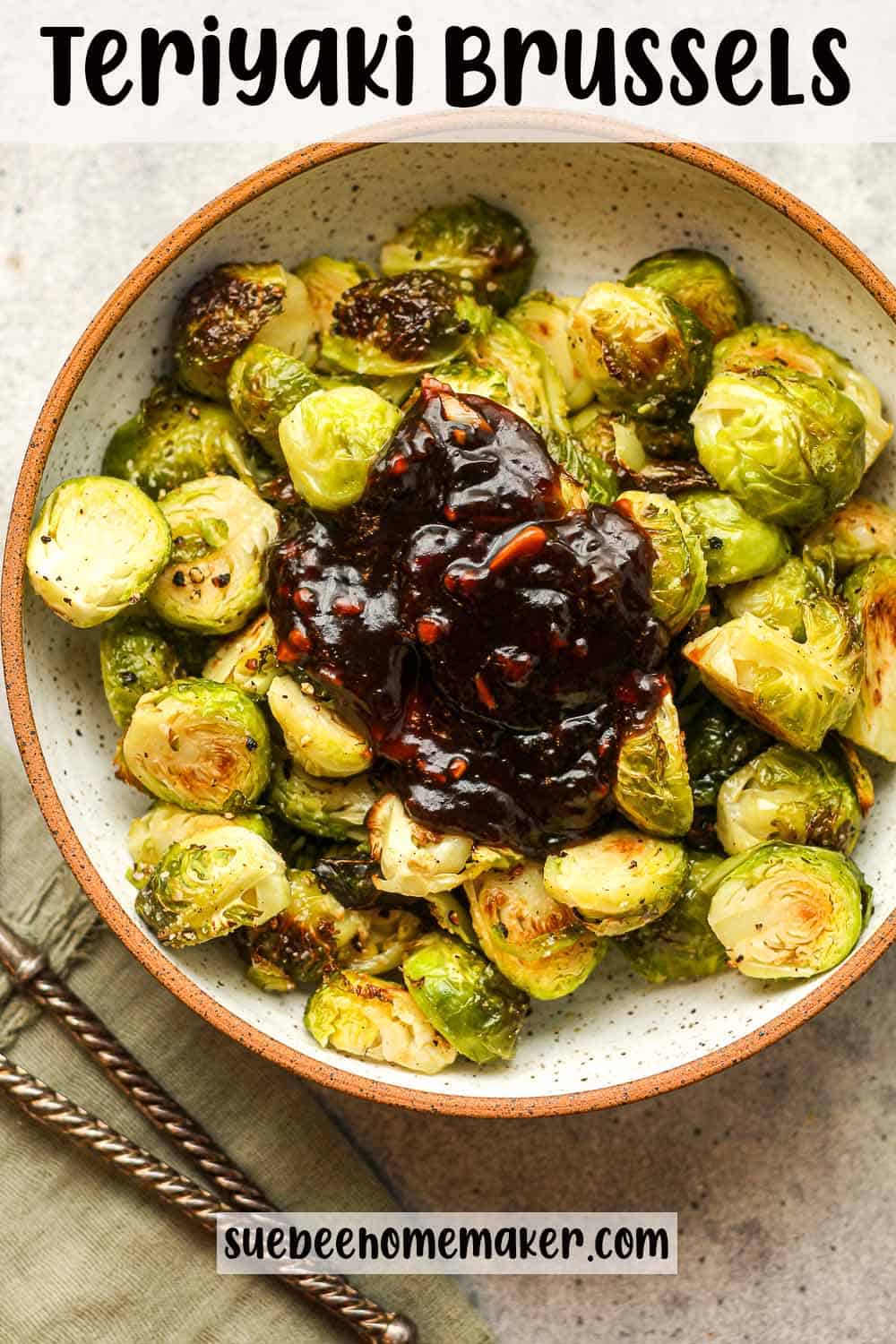 A bowl of roasted brussels sprouts with teriyaki sauce piled on top.