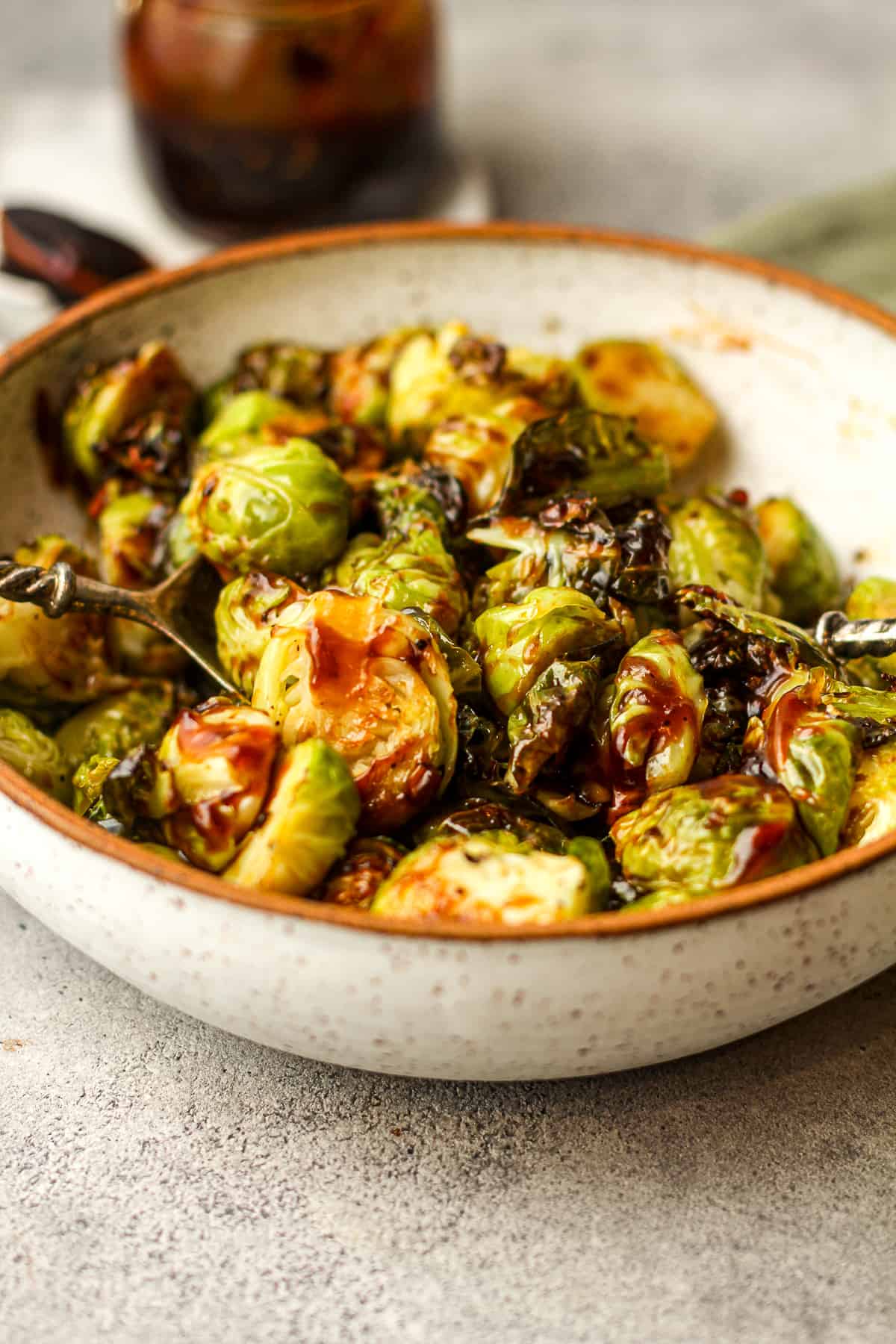 Side view of a bowl of teriyaki brussels sprouts.
