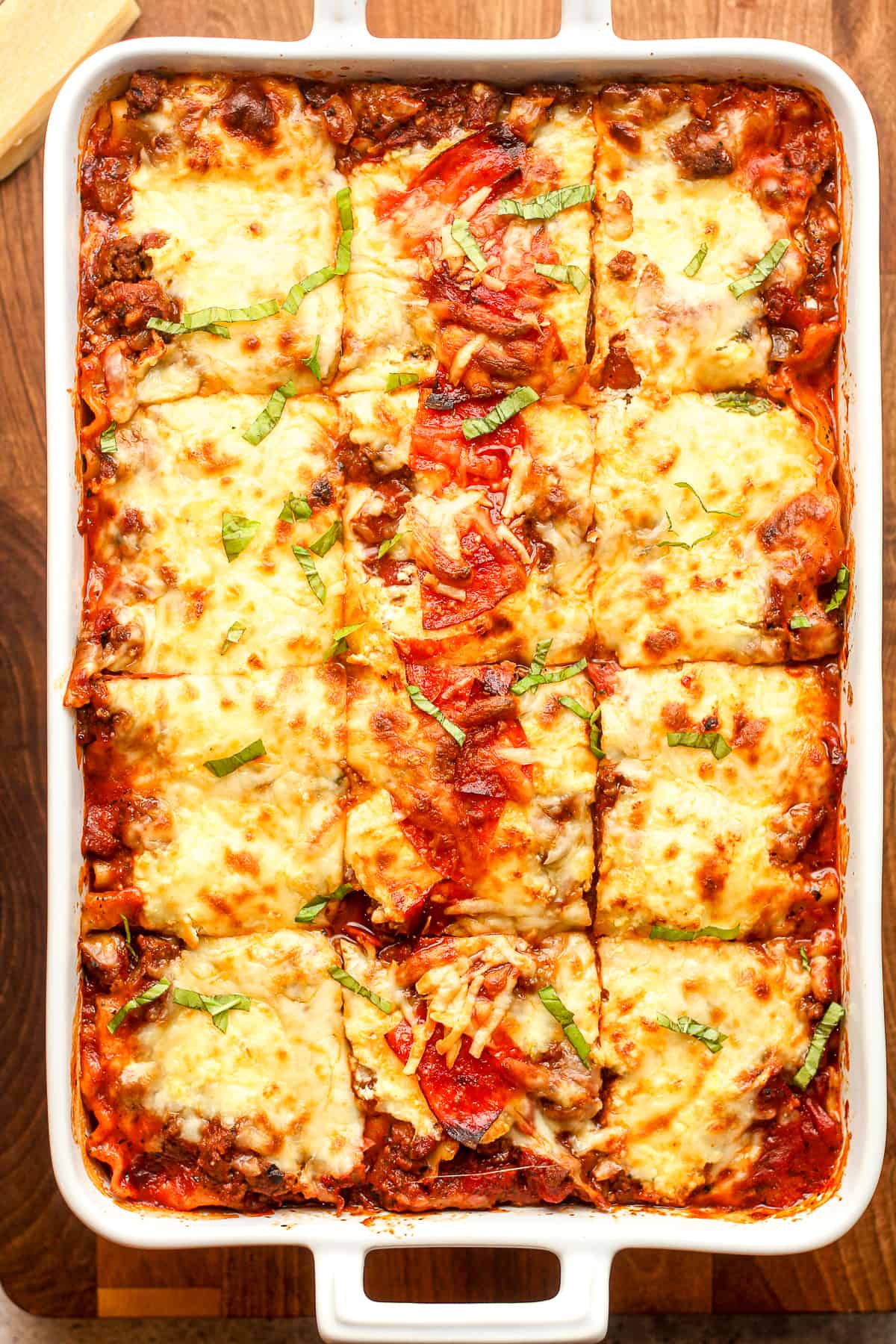 A rectangular casserole of sliced ultimate lasagna with pepperoni.