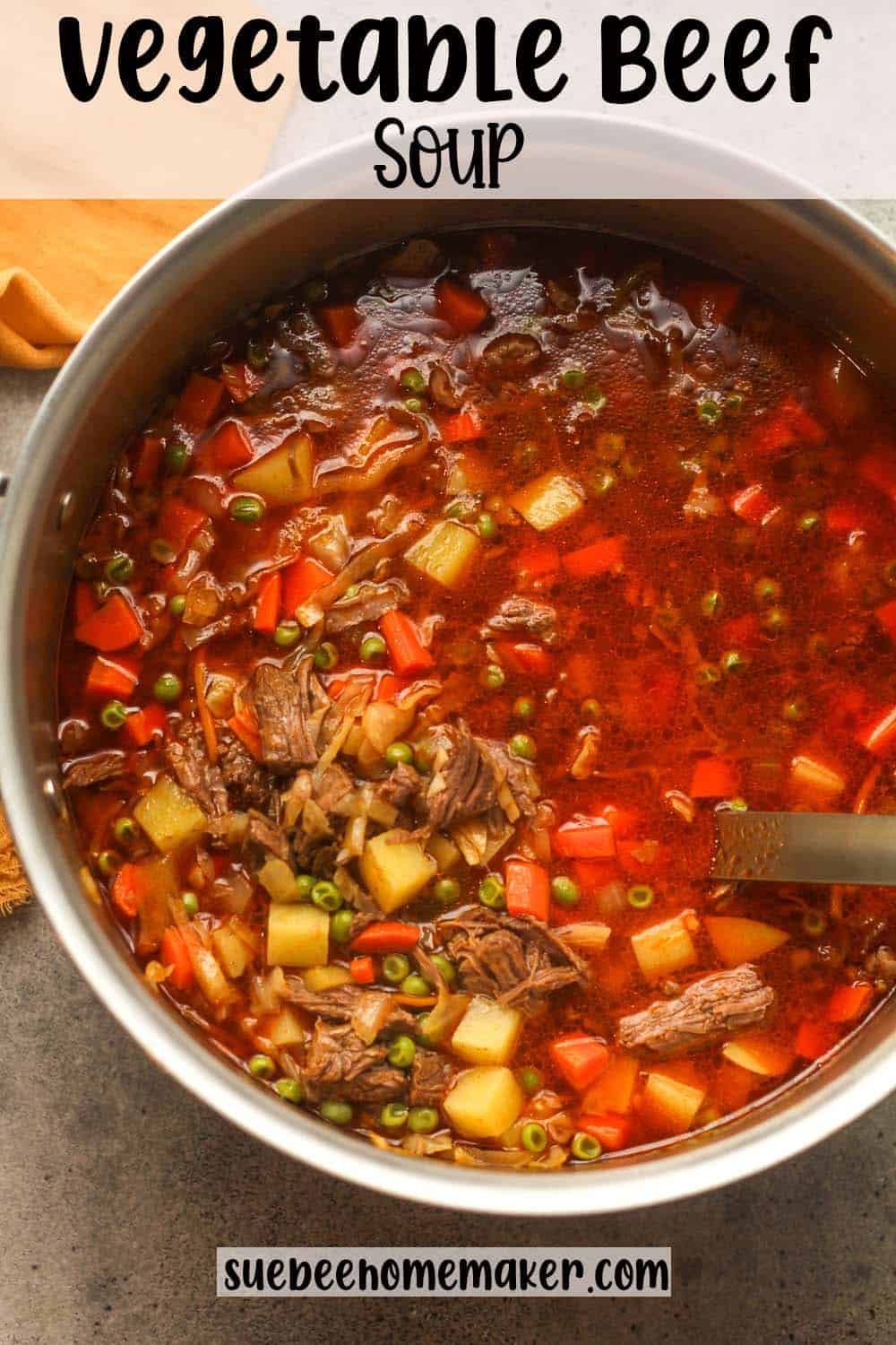 A large pot of vegetable beef soup with a ladle.