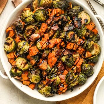 A bowl of balsamic glazed brussels sprouts and sweet potatoes.