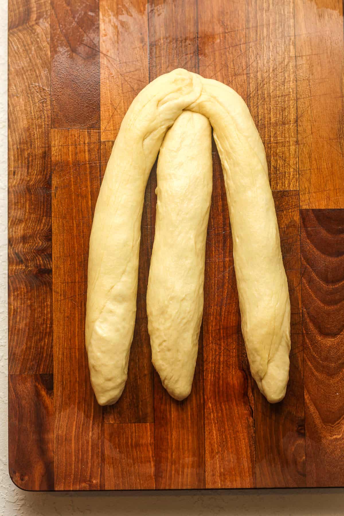 The dough showing the three braids pressed at the top.