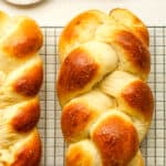 Two loaves of braided brioche bread.