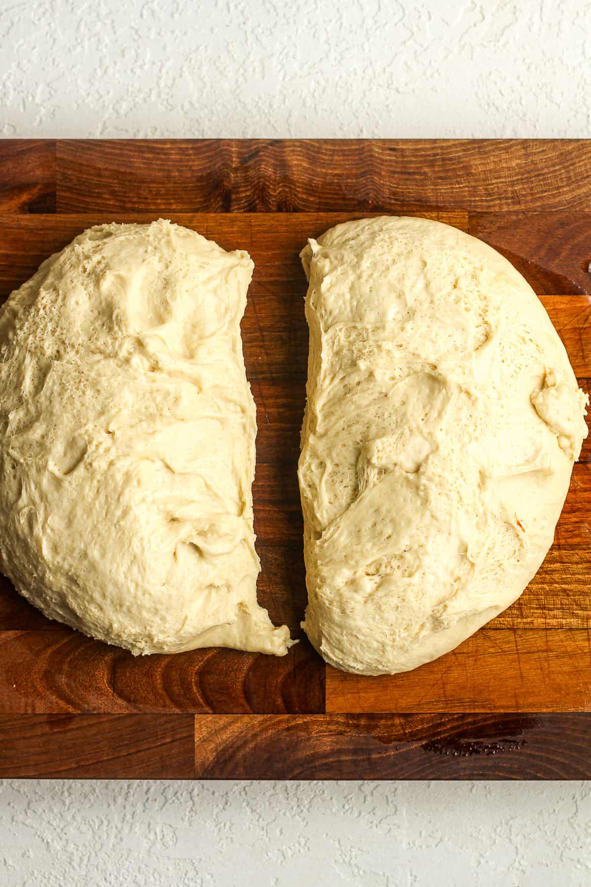 The bread dough divided in half.