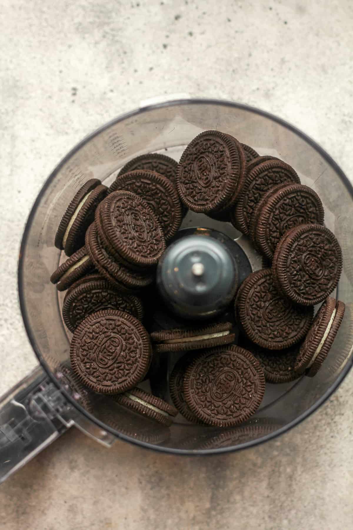A food porcessor with Oreo cookies inside.