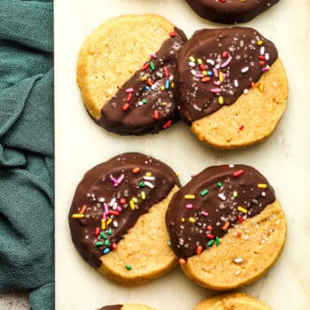 Chocolate dipped shortbread cookies on a white board.