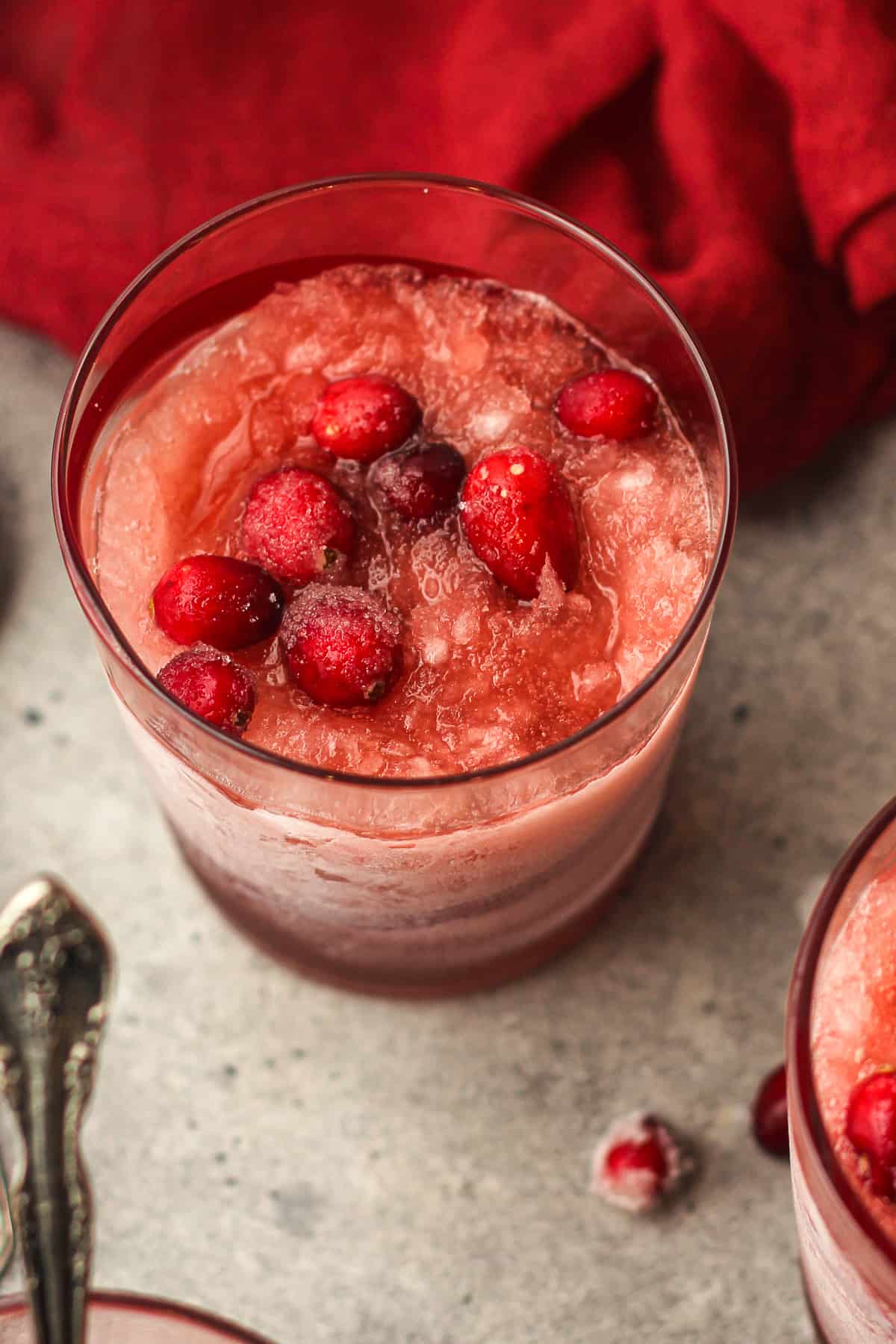 Closeup on a cranberry slush with fresh cranberries inside.
