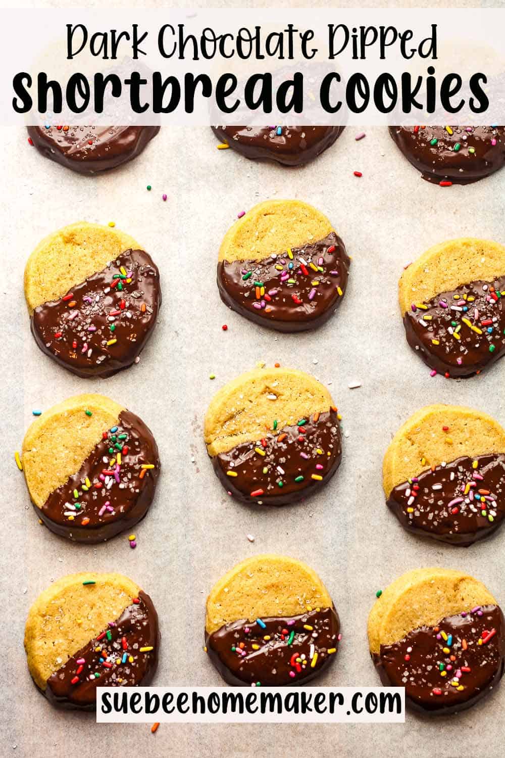 A tray of dark chocolate dipped shortbread cookies with sprinkles.