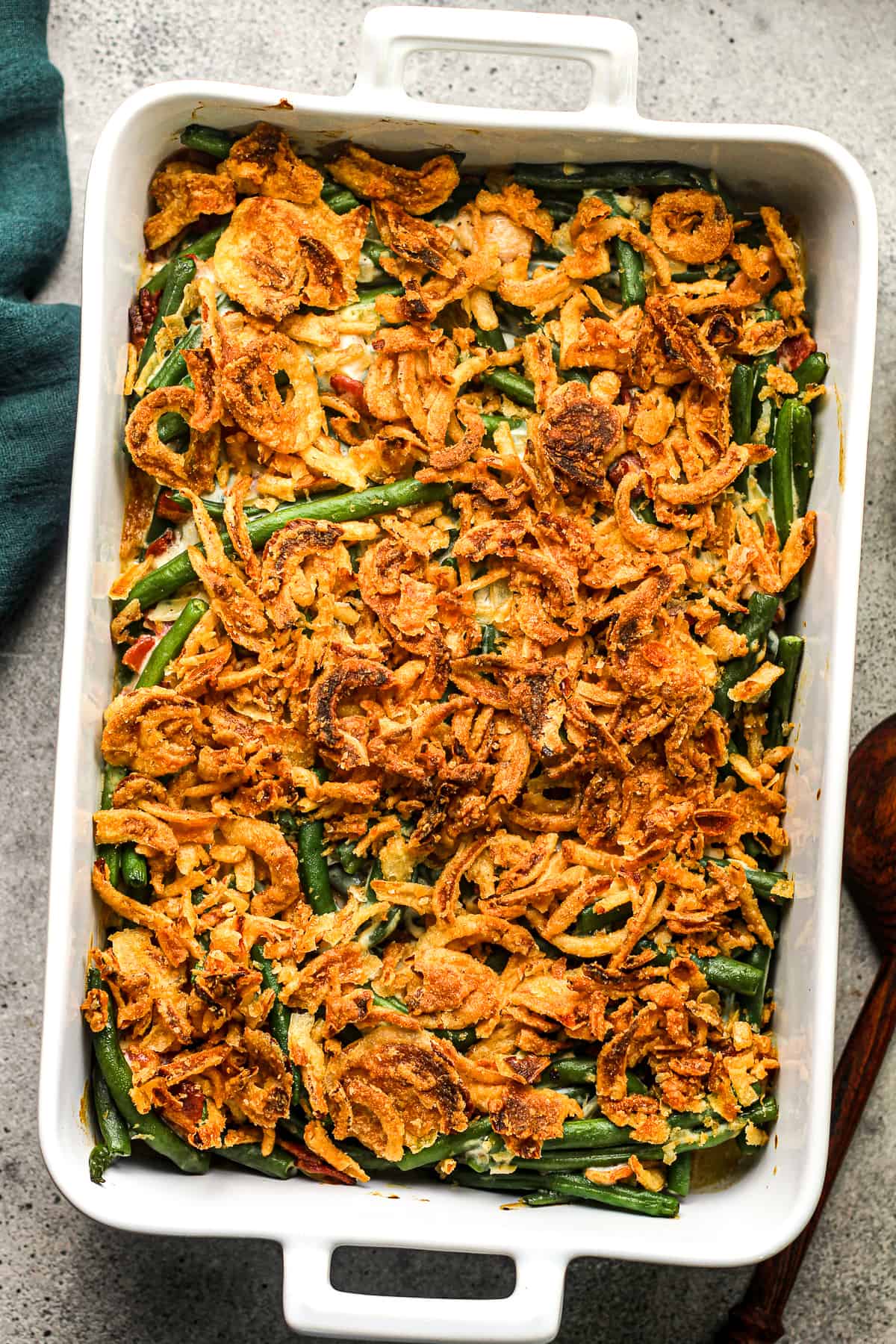 A large 9x13 casserole with green bean casserole with crunchy fried onions.
