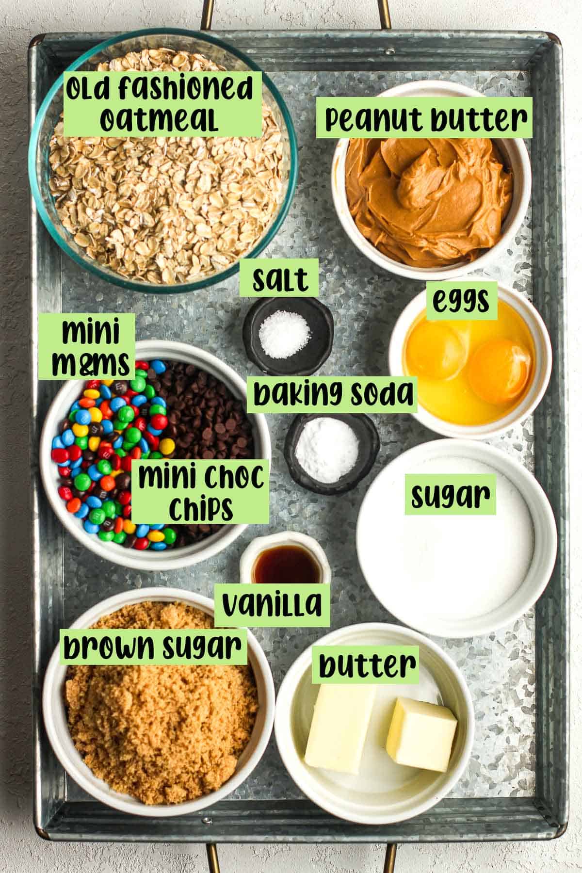 A tray of the monster cookie ingredients with labels.