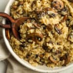 A bowl of creamy mushroom risotto with a spoon.