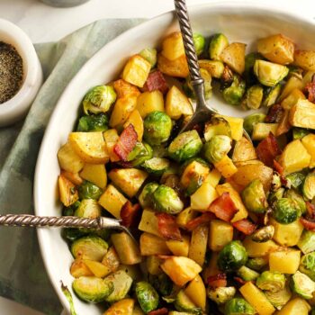 A bowl of roasted potatoes and Brussels sprouts with bacon.