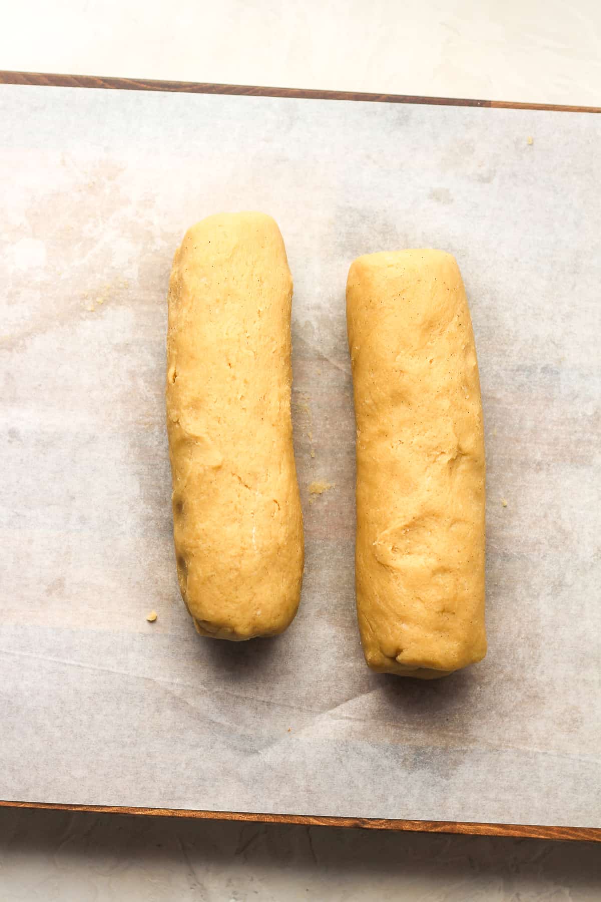 Two rolls of shortbread cookie dough.