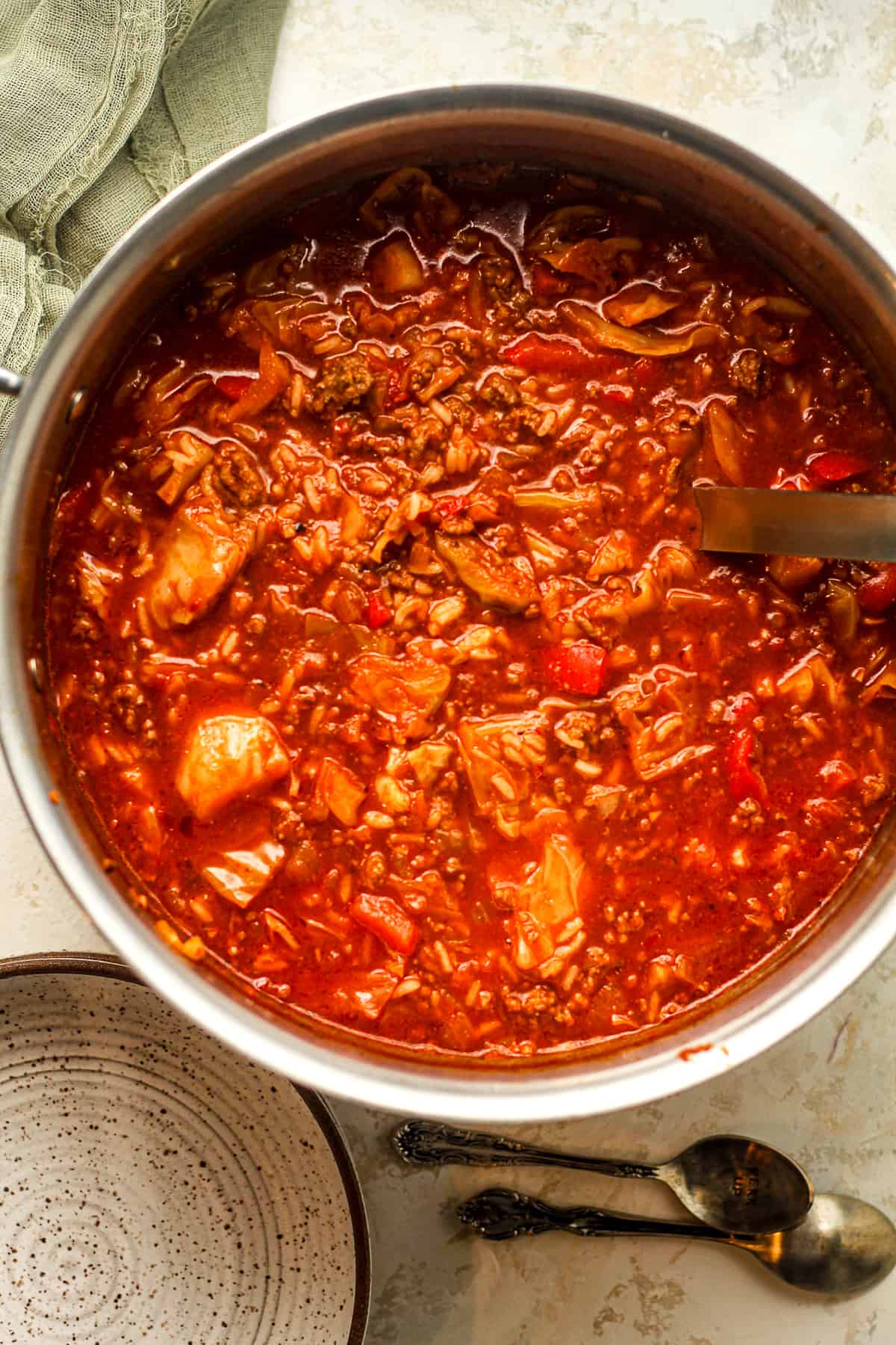 Overhead view of a large pot of stuffed cabbage soup.