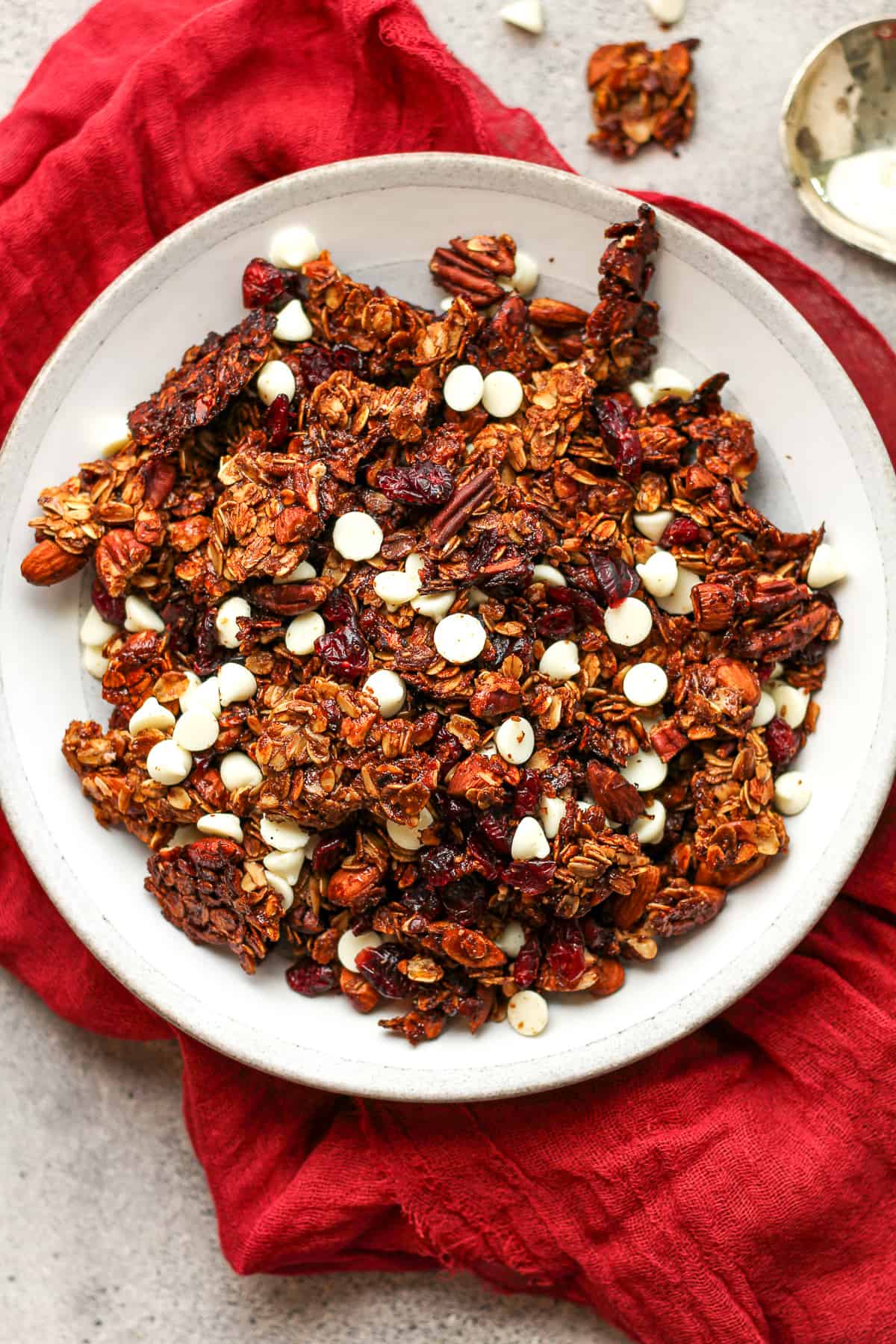 A shallow bowl of gingerbread granola with raisins.