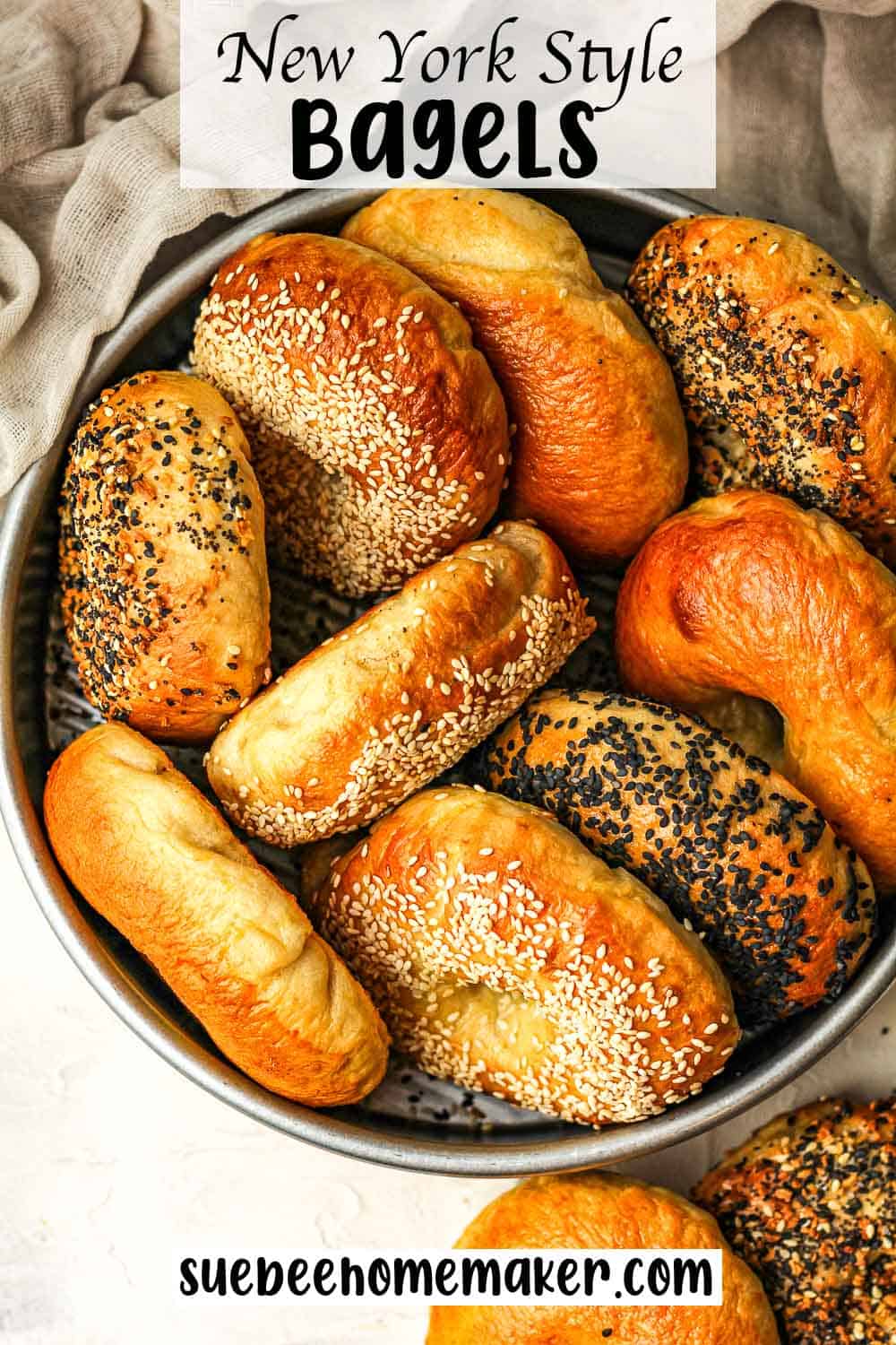 A round pan of New York Style Bagels with various toppings.