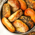Overhead view of a pan of stacked bagels.