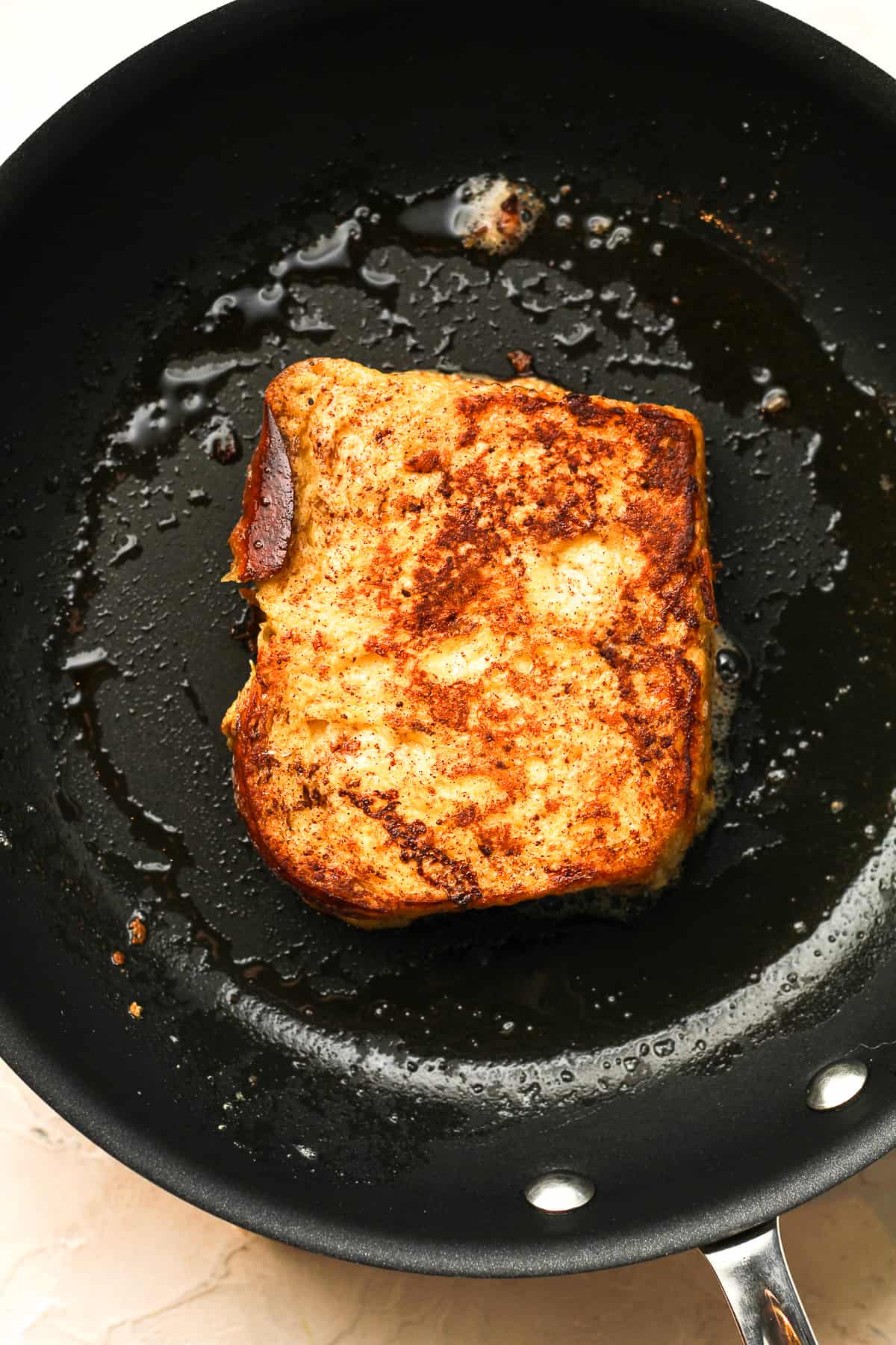 A nonstick skillet with a piece of French toast.