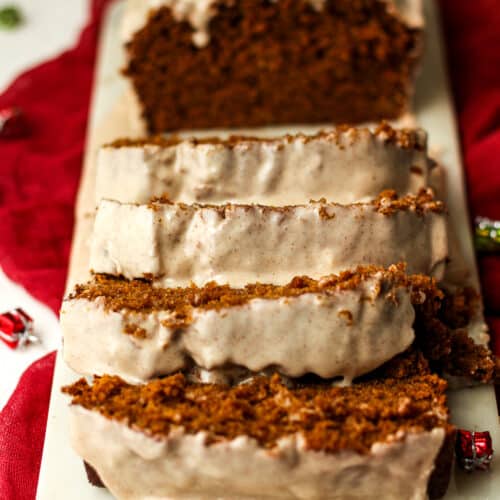 Side view of some sliced gingerbread loaf with icing.