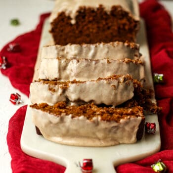 Sliced gingerbread loaf with drippy icing.