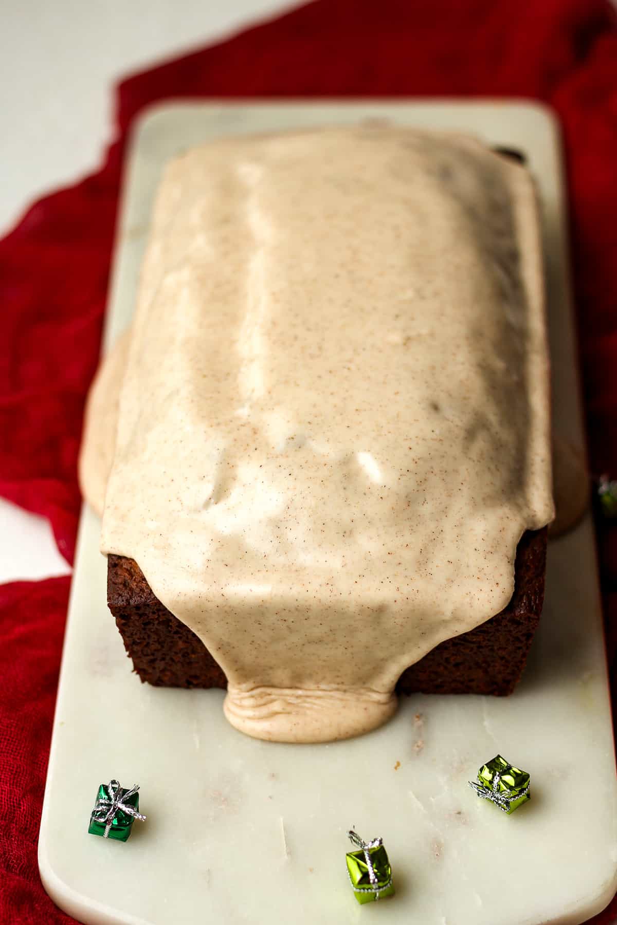 Side view of an iced gingerbread loaf.