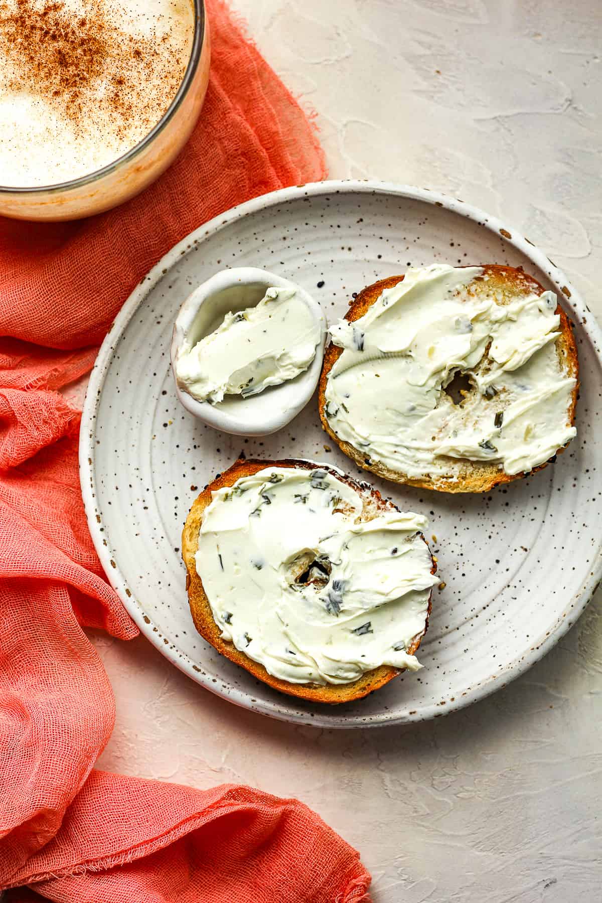 a toasted bagel with chive cream cheese.