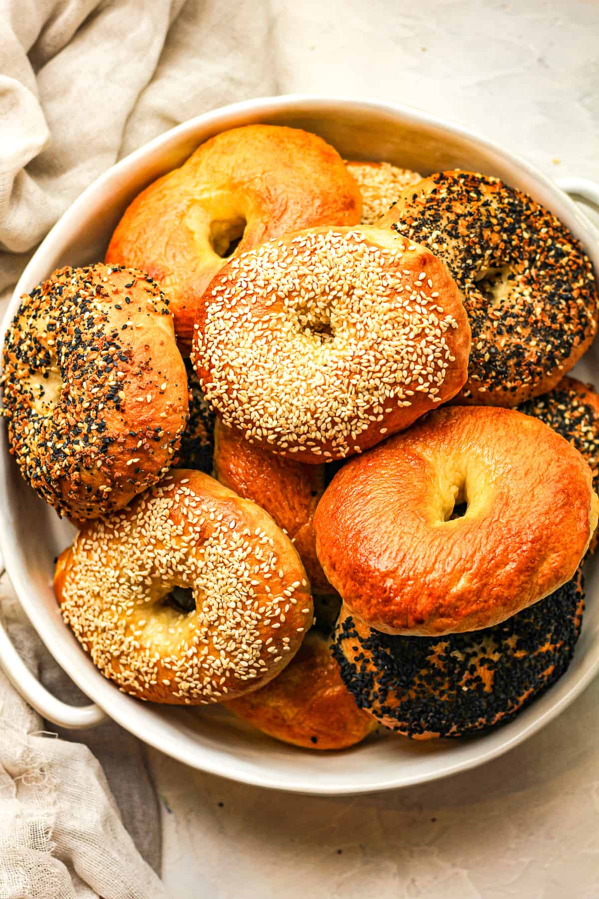 Overhead view of a bowl of stacked bagels.