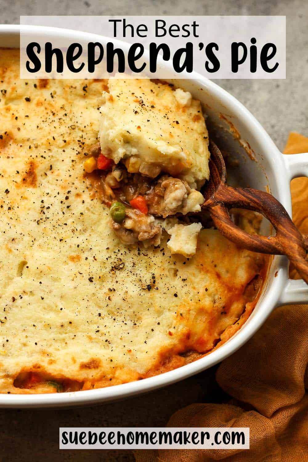 A casserole dish with a spoonful of shepherd's pie.