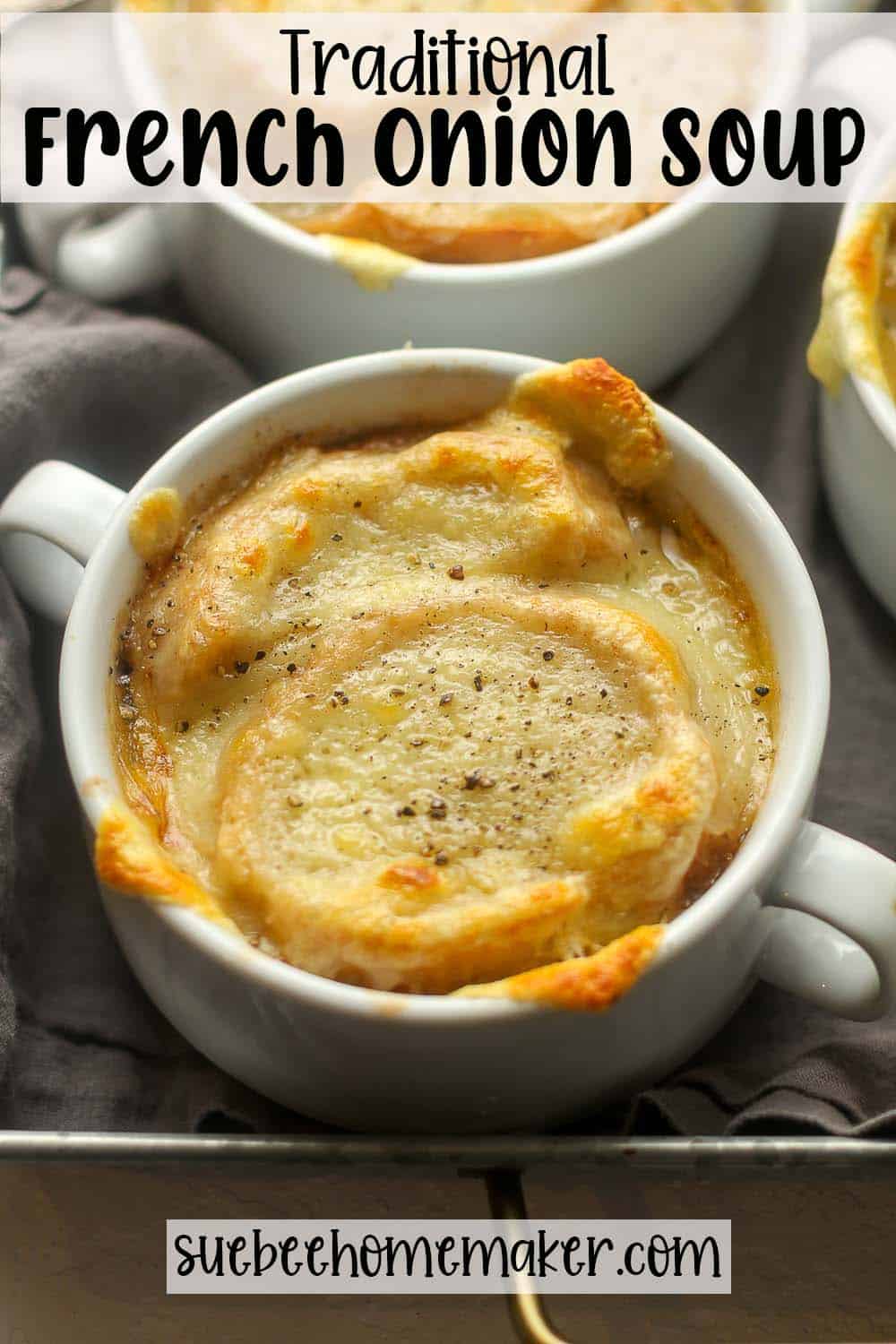 Side view of some mugs of traditional French Onion soup.