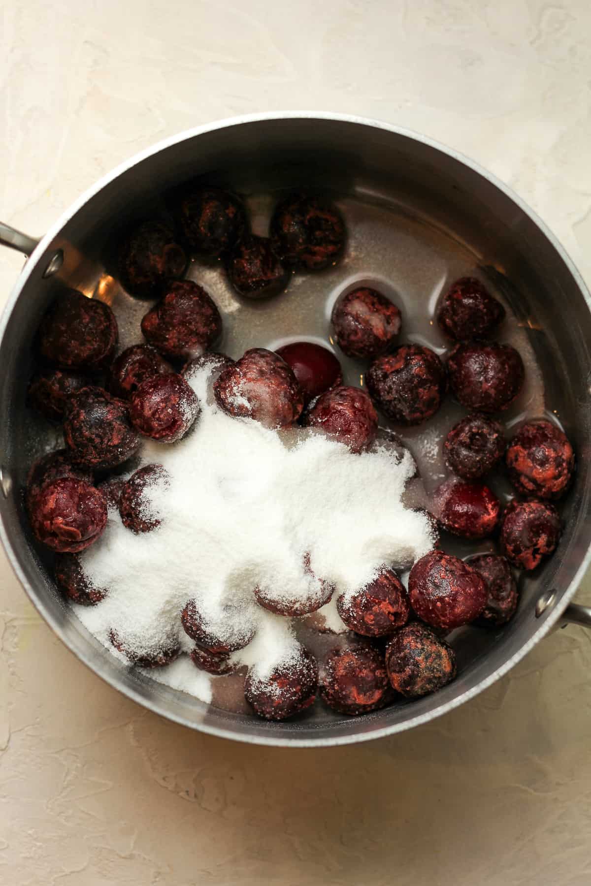 A pan of the frozen cherries and sugar.
