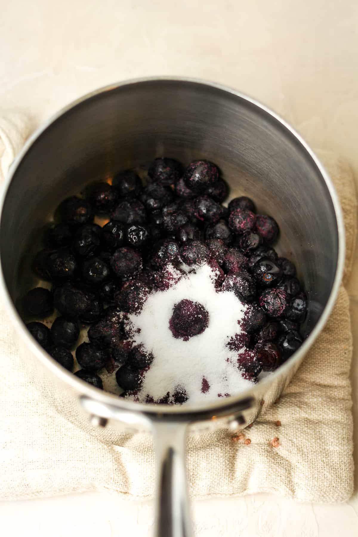 A pan of frozen blueberries with sugar.