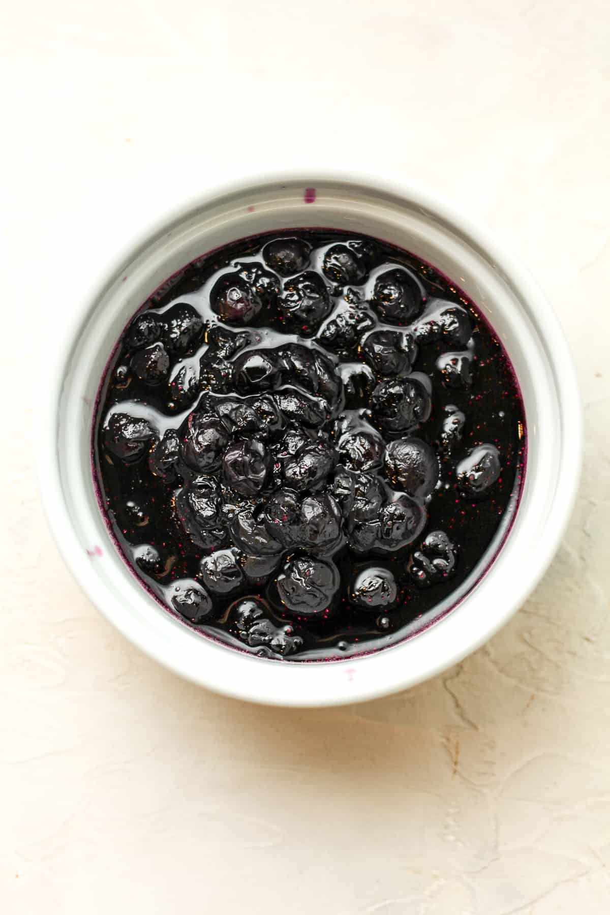 A bowl of cooked blueberries.