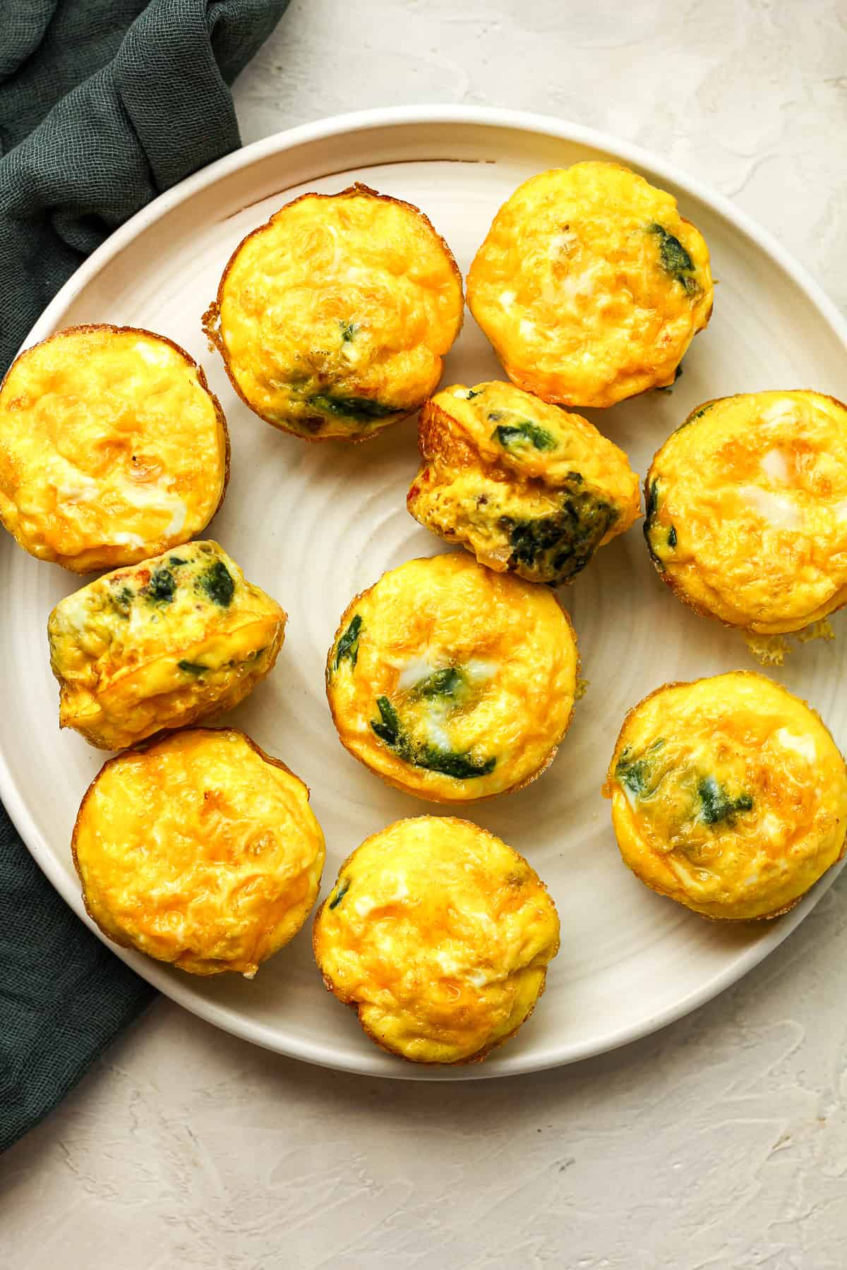 A large plate of sausage and egg muffins.