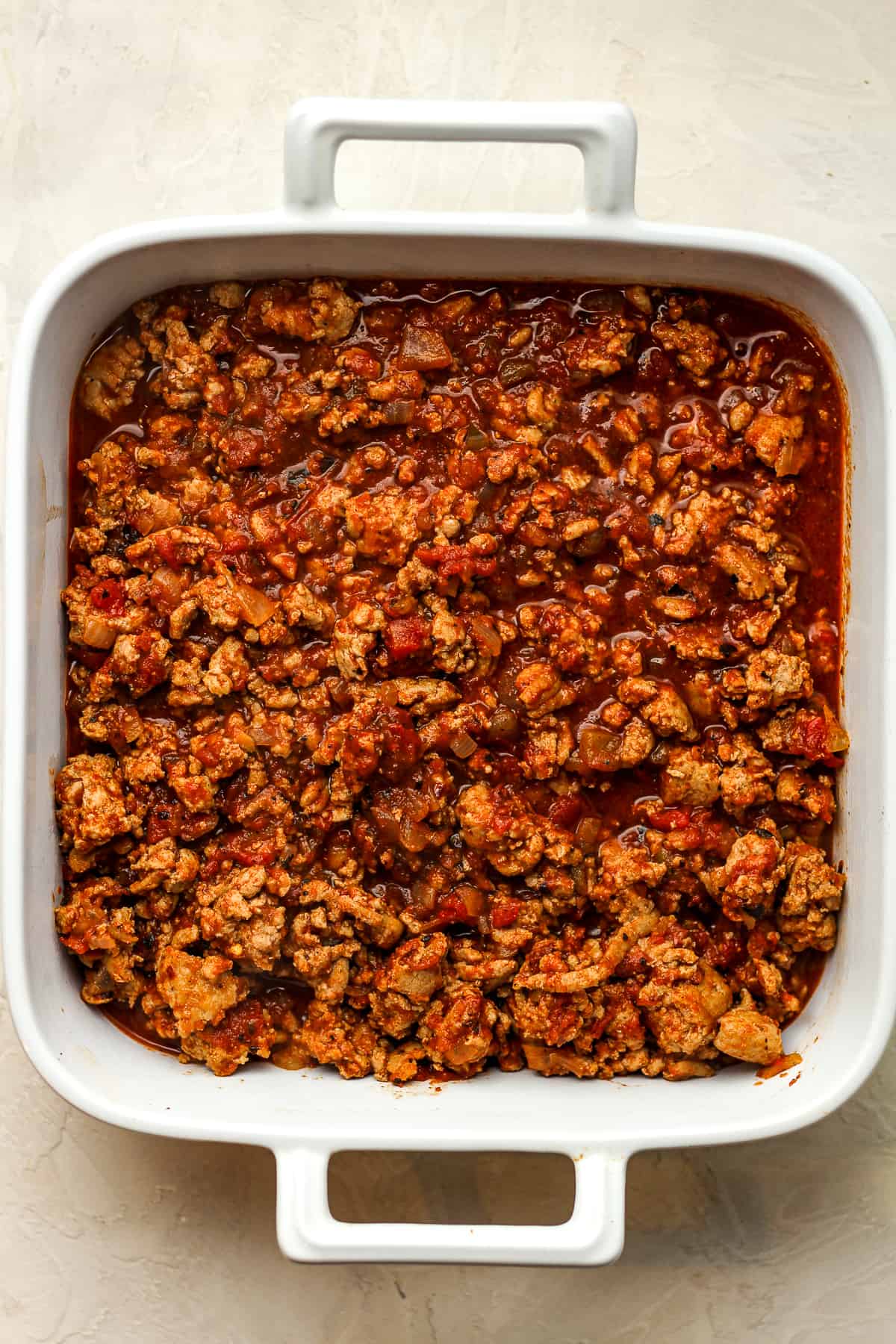 A dish of the meat mixture with tomatoes.