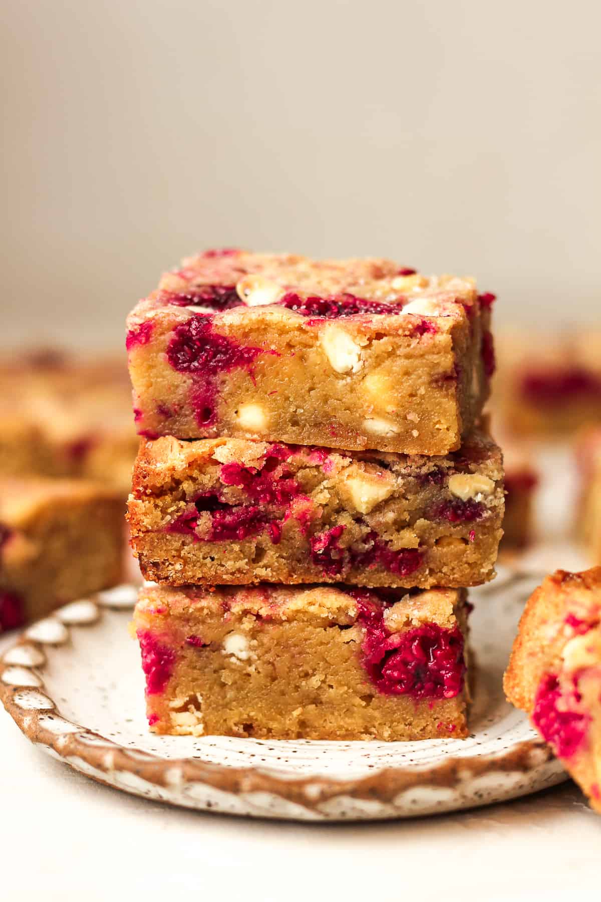 Three stacked blondies on a small plate.