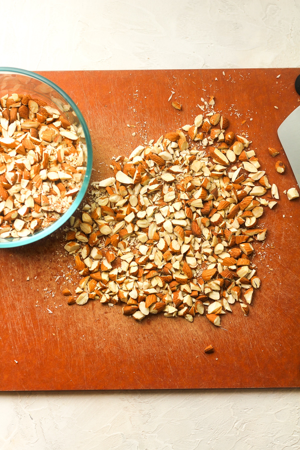 A cutting board of chopped almonds.
