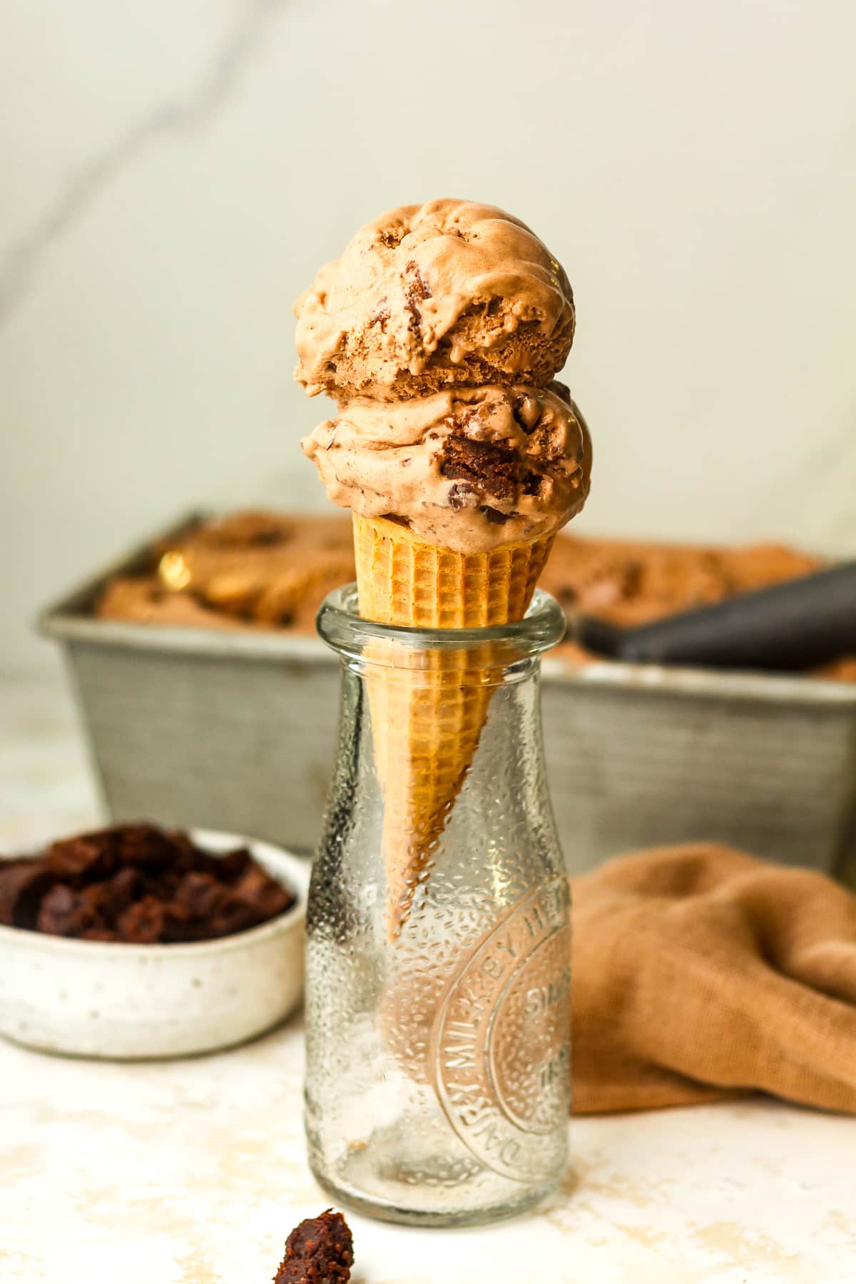 A jar with a double dip of chocolate brownie ice cream cone.