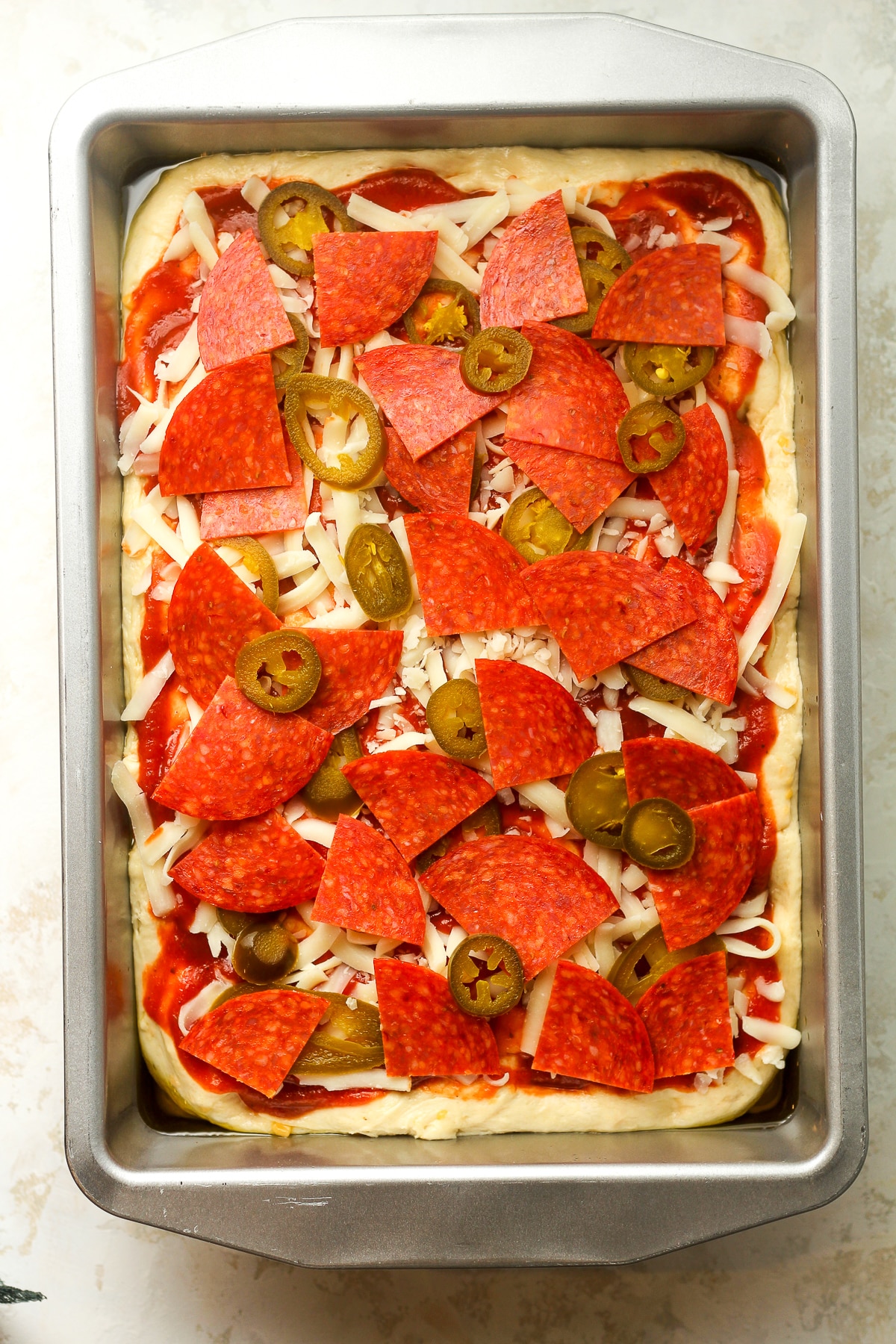 A pan of the focaccia pizza before baking.