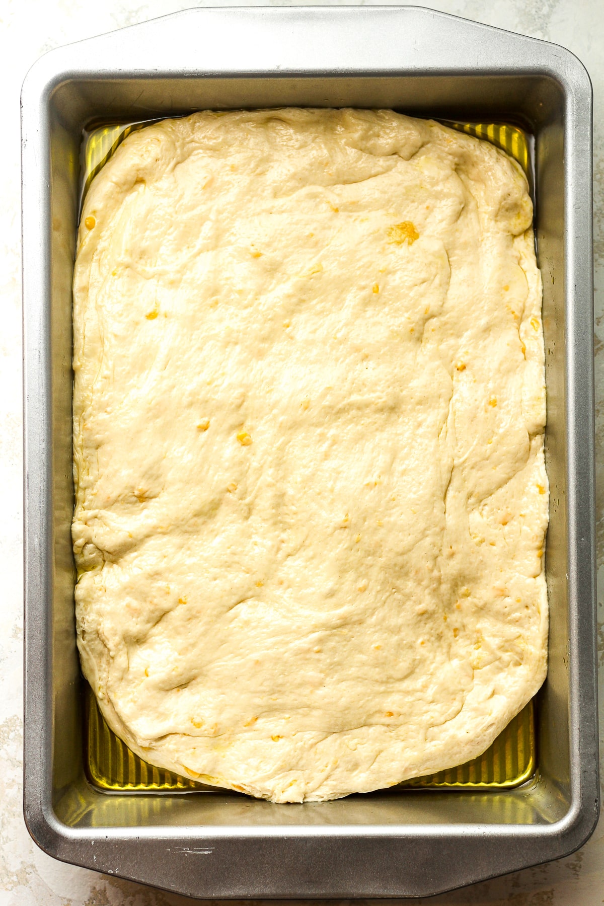 A pan of the dough wit olive oil.